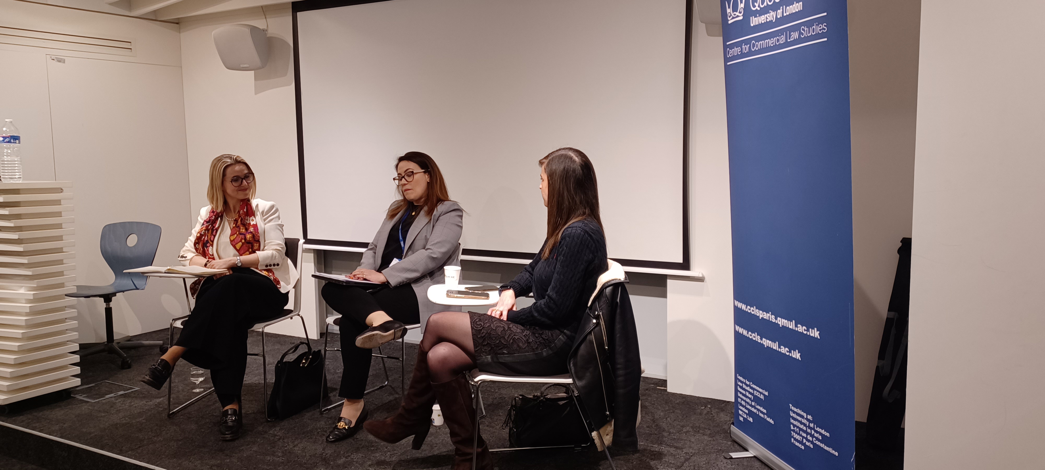 Three speakers sitting on a panel