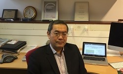 Professor Yang Hao sitting down looking at camera