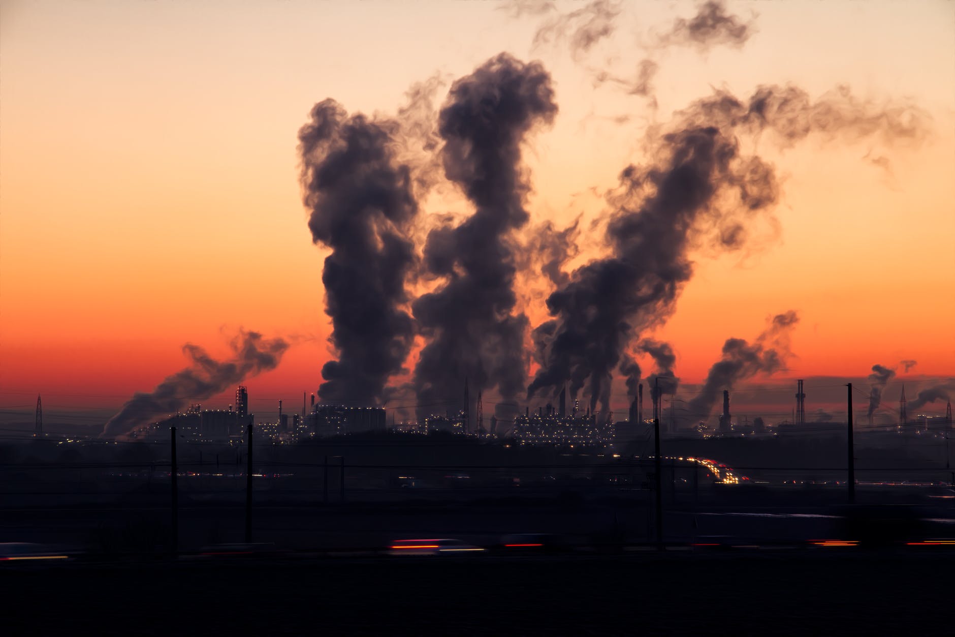 Building at sunset with smoke floating into the sky