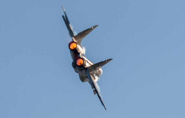A military aircraft flying in the sky