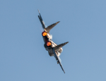 A military aircraft flying in the sky