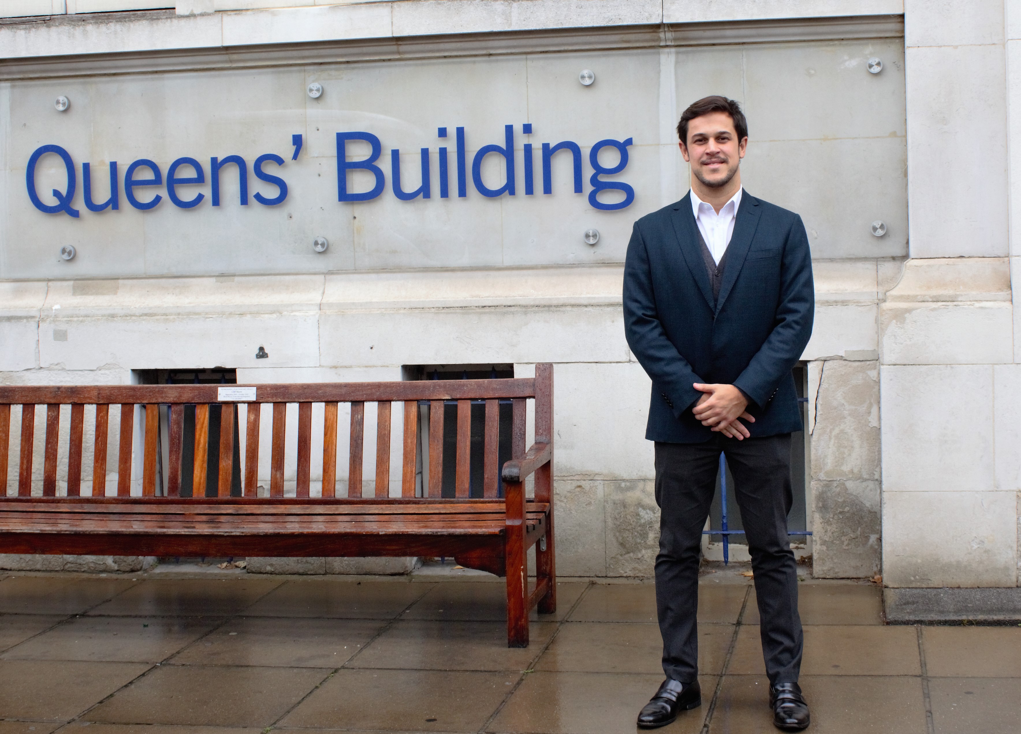 Alumnus Cassio Mosse outside Queens' Building