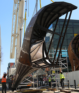Crane lifting of Neuron Pod's final leg