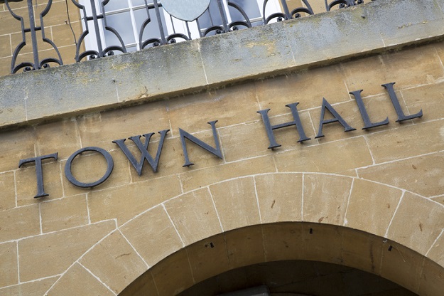 Photo of a sign saying 'Town Hall' on a brick building. Location unknown.
