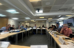 Participants at the QMIPRI evergreening workshop. The desks are arranged so participants are facing inwards.