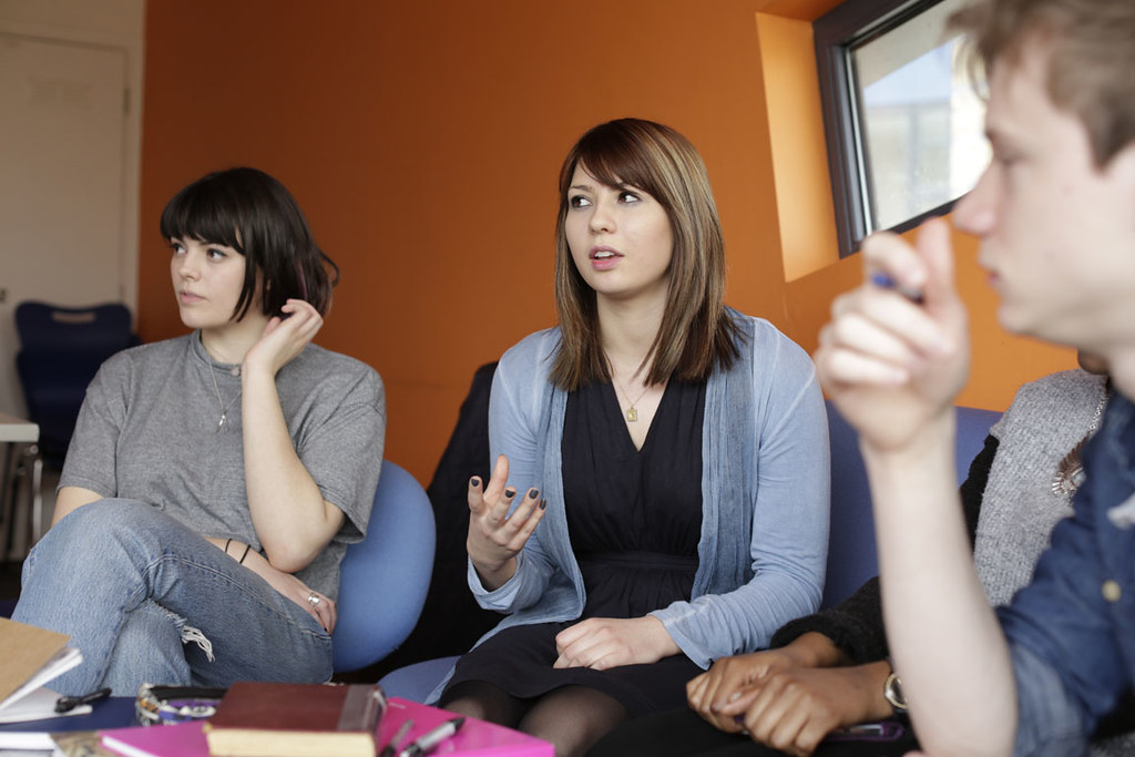 A group of four students in conversation