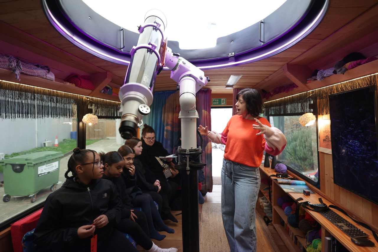 Students and artist on board moon palace bus