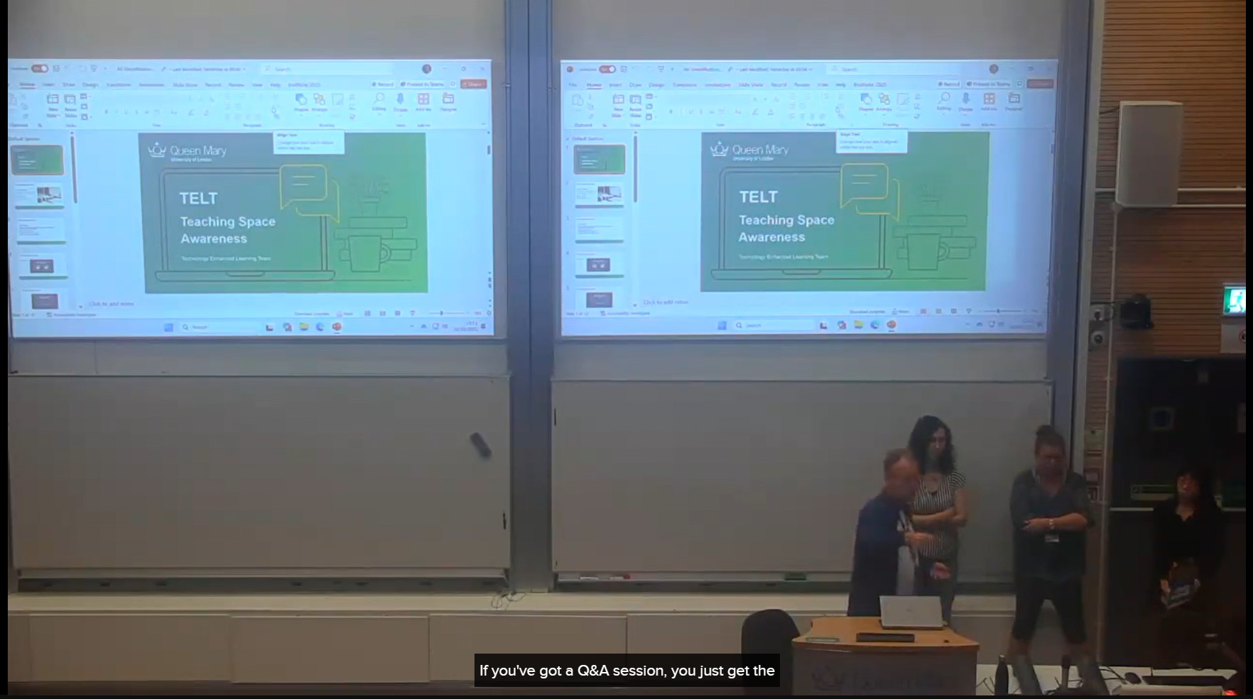 Frame showing a lecture in progress with with live captions displayed at the bottom of the frame.