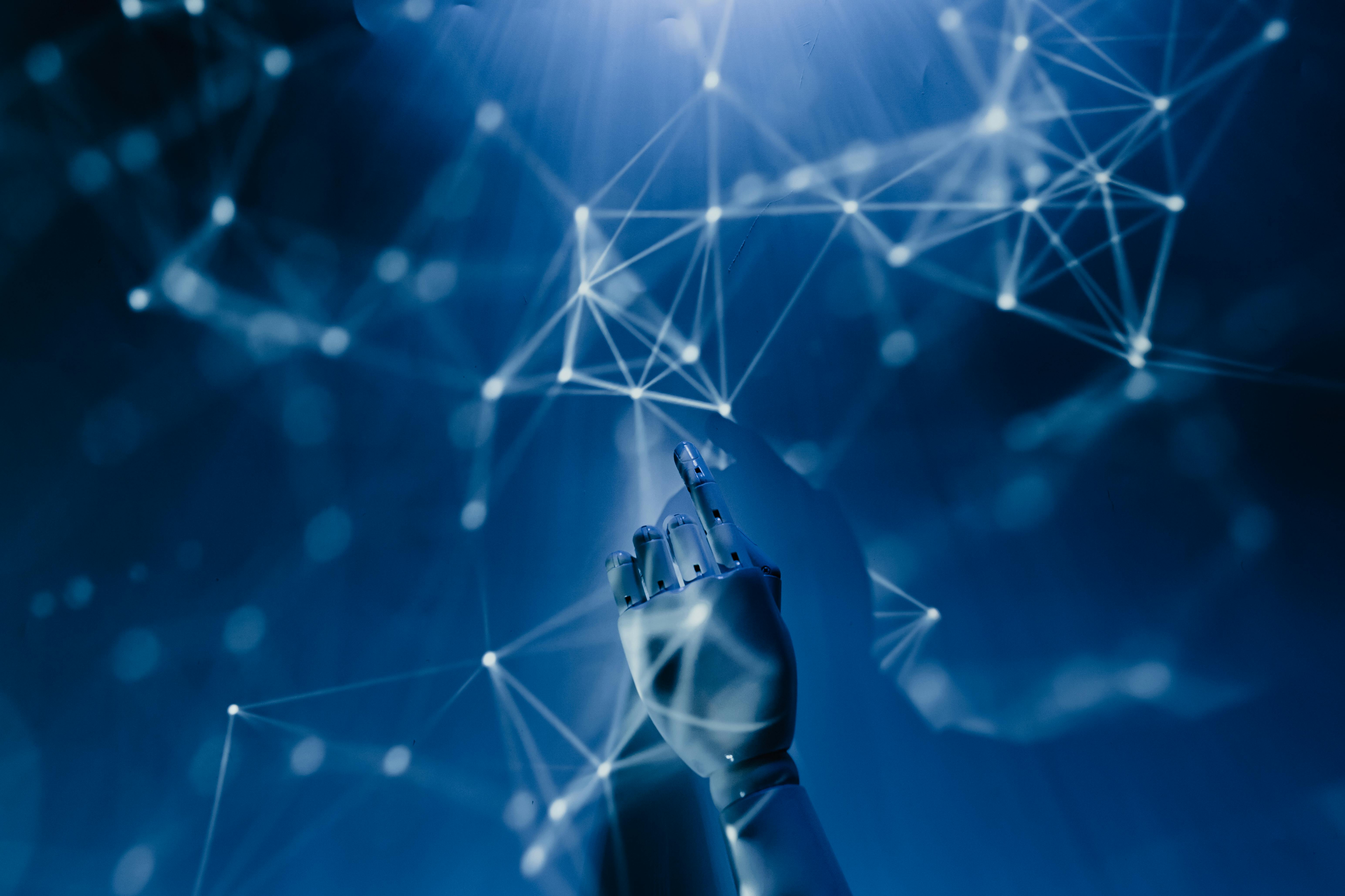 Robotic hand reaching toward a glowing digital network of nodes and lines on a dark blue background