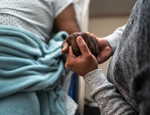 Patient holding hand